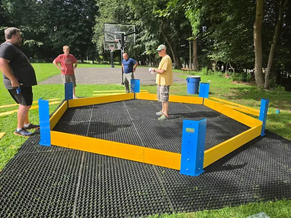Dad volunteers building the Gaga pit.